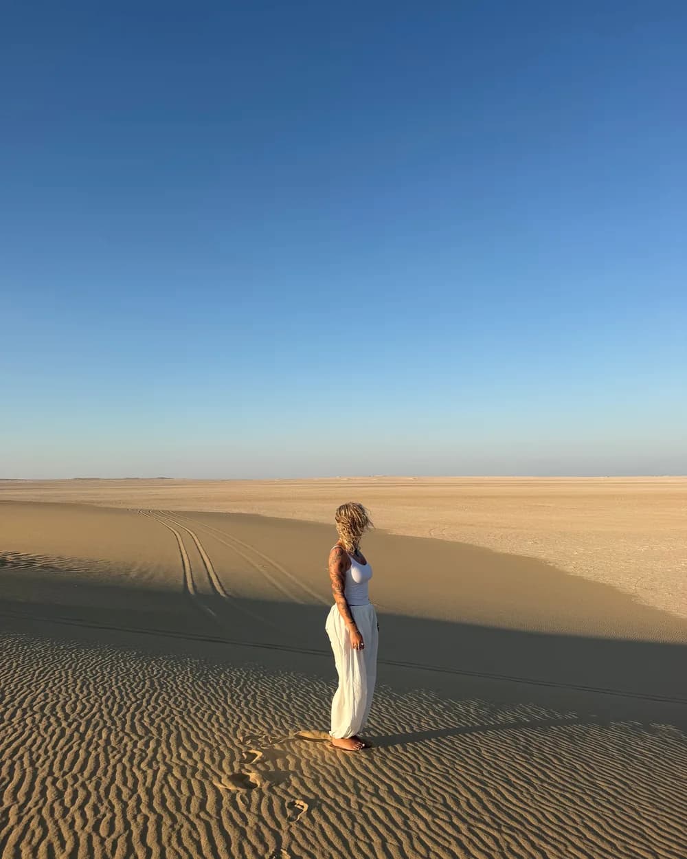 A traveller standing alone on the dunes