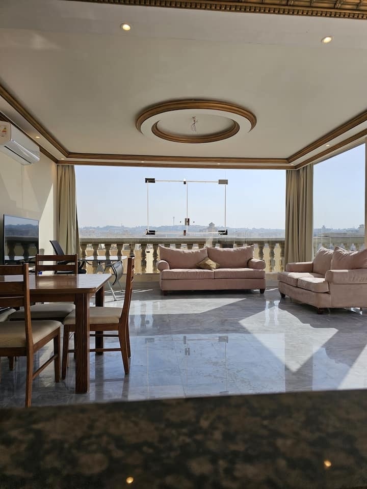 The penthouse living and dining room with terrace views