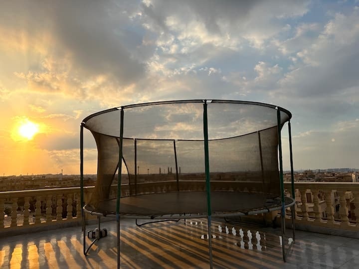 The penthouse terrace with a trampoline at sunset